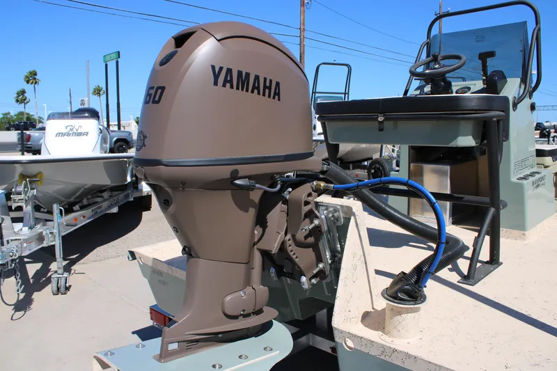 Slide: The Image of Outboard motor on Freedom 14 CHIQUITA boat, 2026 model, in a sunny outdoor setting. - 7
