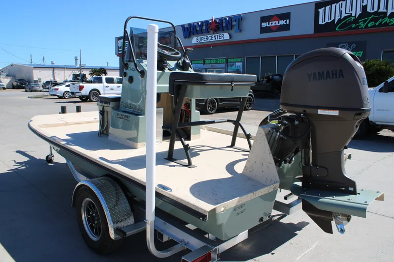 Slide: The Image of 2026 Freedom 14 Chiquita boat with Yamaha engine at dealership parking lot. - 8