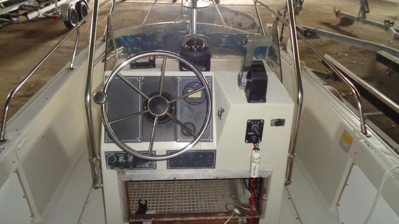 Slide: The Image of 1987 Boston Whaler 18 Outrage boat console with steering wheel and controls. - 11