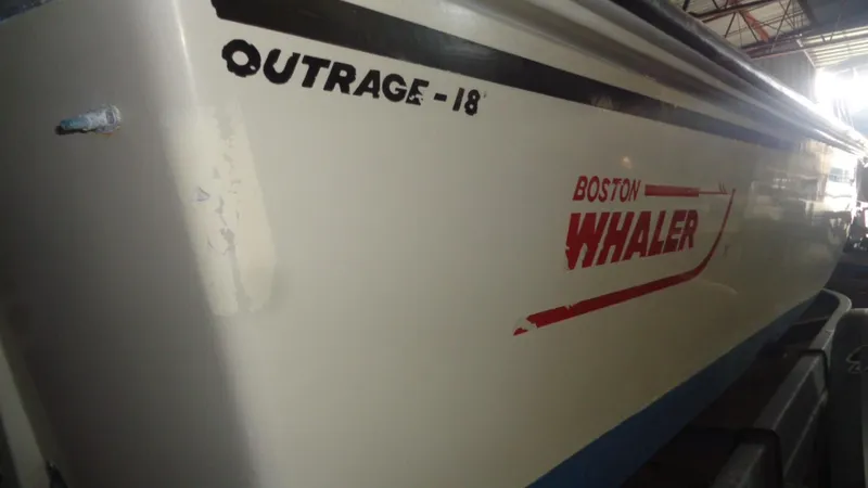 Slide: The Image of 1987 Boston Whaler 18 Outrage boat, side view with logo and model name. - 15
