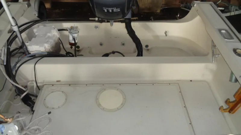 Slide: The Image of 1987 Boston Whaler 18 Outrage boat interior with Yamaha 115 engine, showing deck and wiring. - 16