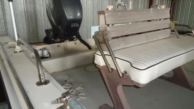 Slide: The Image of 1987 Boston Whaler 18 Outrage boat interior with Yamaha 115 engine and seating. - 18