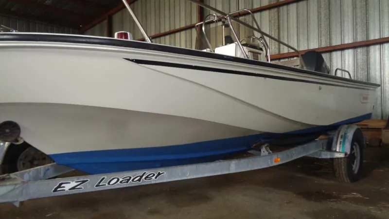Slide: The Image of 1987 Boston Whaler 18 Outrage boat on EZ Loader trailer in storage. - 6