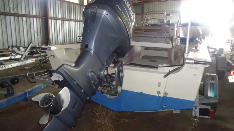 Slide: The Image of 1987 Boston Whaler 18 Outrage with Yamaha outboard motor in storage. - 8