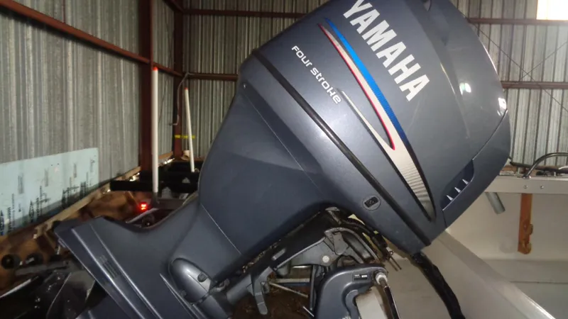 Slide: The Image of 1987 Boston Whaler 18 Outrage with Yamaha four-stroke outboard motor in storage. - 9