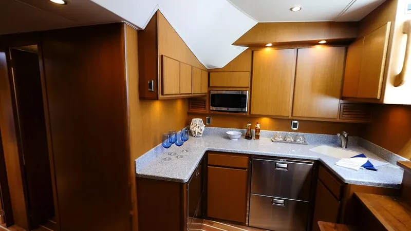 Slide: The Image of Modern kitchen in 2025 Henriques 50 EXHT yacht with wooden cabinets and stainless steel appliances. - 10