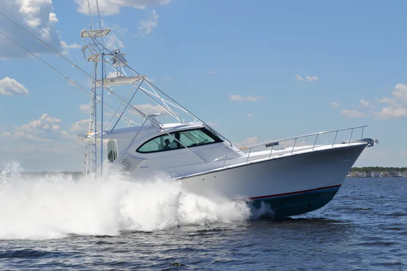 Slide: The Image of 2026 Henriques 50 EXHT yacht cruising on open water under a clear blue sky. - 3