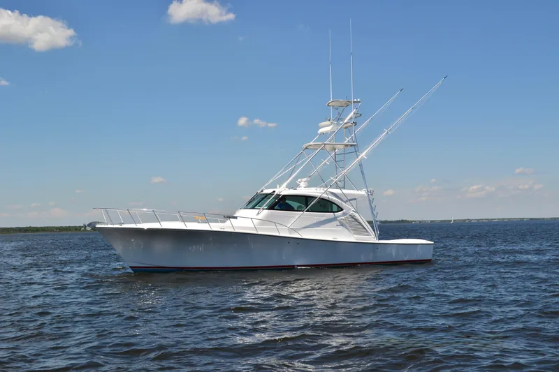 Slide: The Image of 2026 Henriques 50 EXHT yacht on open water under clear blue sky. - 4