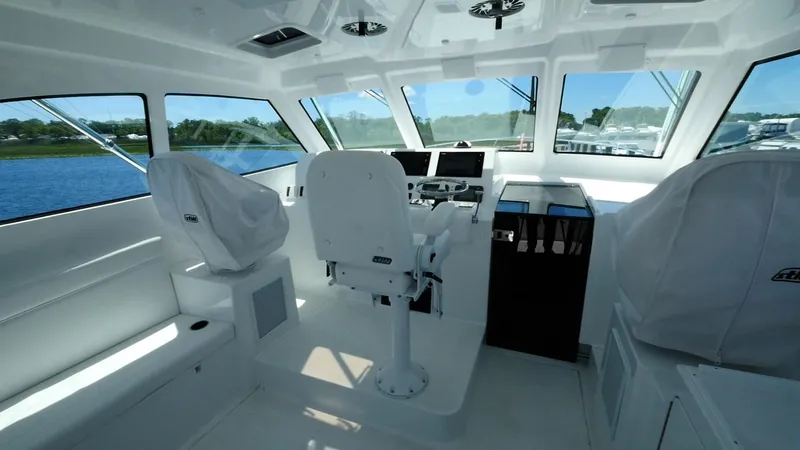Slide: The Image of 2025 Henriques 50 EXHT boat interior with helm station and seating. - 7