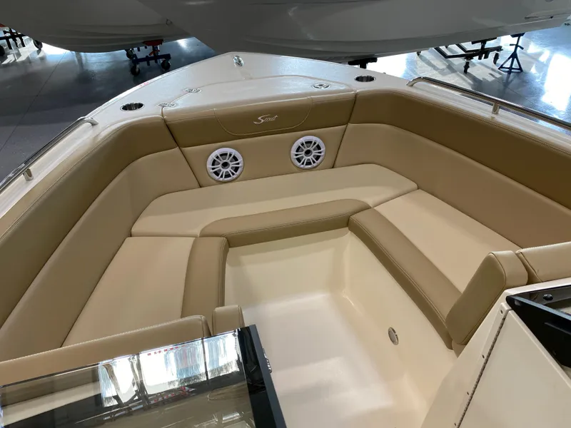 Slide: The Image of 2024 Scout 215 Dorado boat interior with beige seating and built-in speakers. - 7