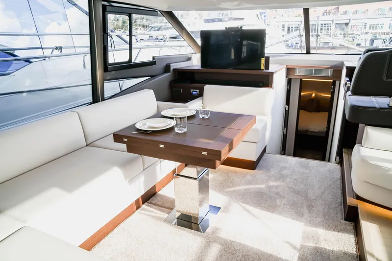 Slide: The Image of Luxurious interior of 2024 Prestige 590 yacht with dining area and modern amenities. - 12