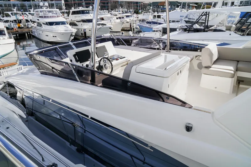 Slide: The Image of 2024 Prestige 590 yacht at marina, showcasing sleek design and luxurious amenities. - 17