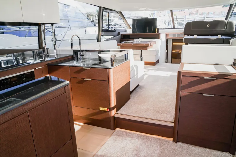 Slide: The Image of Luxurious interior of 2024 Prestige 590 yacht with modern kitchen and seating area. - 7