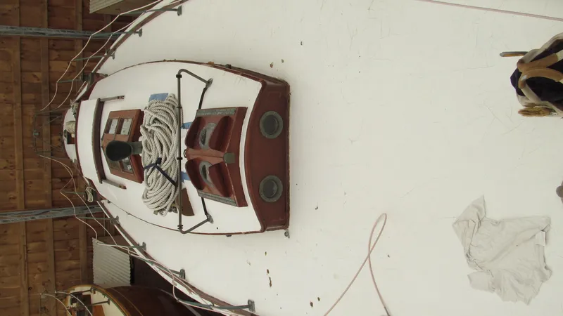 Slide: The Image of 1951 Concordia Yawl sailboat with coiled rope on deck, stored indoors. - 4