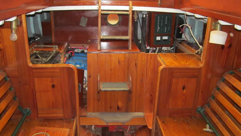 Slide: The Image of Interior of a 1951 Concordia Yawl sailboat with wooden paneling and seating. - 7