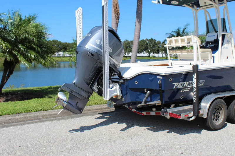 Slide: The Image of 2017 Pathfinder 2500 Hybrid boat on trailer by a lake. - 11