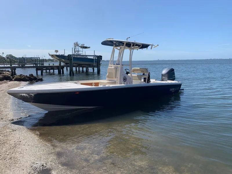Slide: The Image of 2017 Pathfinder 2500 Hybrid boat docked by the shore. - 17