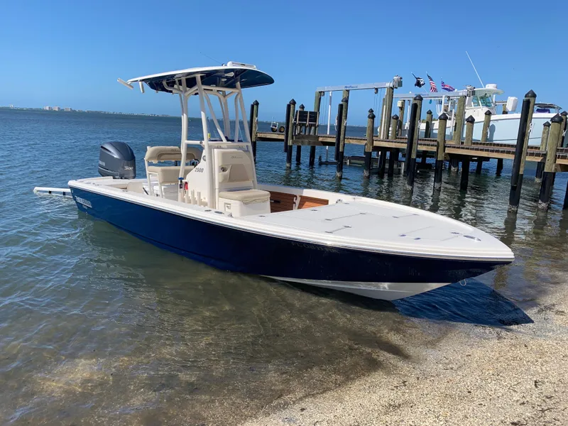 Slide: The Image of 2017 Pathfinder 2500 Hybrid boat docked by the shore on a sunny day. - 18