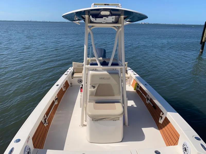 Slide: The Image of 2017 Pathfinder 2500 Hybrid boat on calm water, featuring spacious deck and seating. - 22