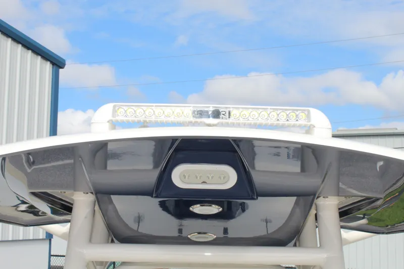 Slide: The Image of 2017 Pathfinder 2500 Hybrid boat with T-top and LED lights against blue sky. - 26