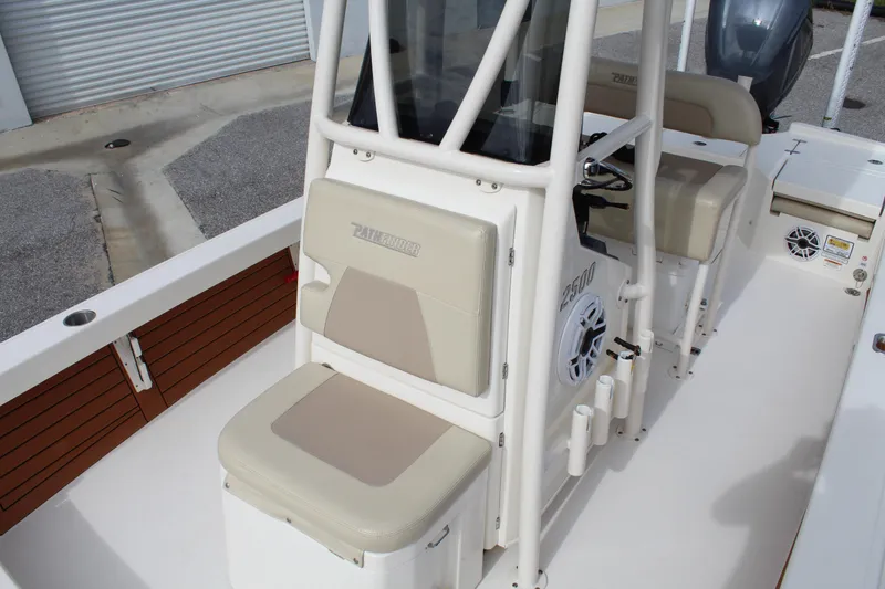 Slide: The Image of 2017 Pathfinder 2500 Hybrid boat interior with beige seating and console. - 29