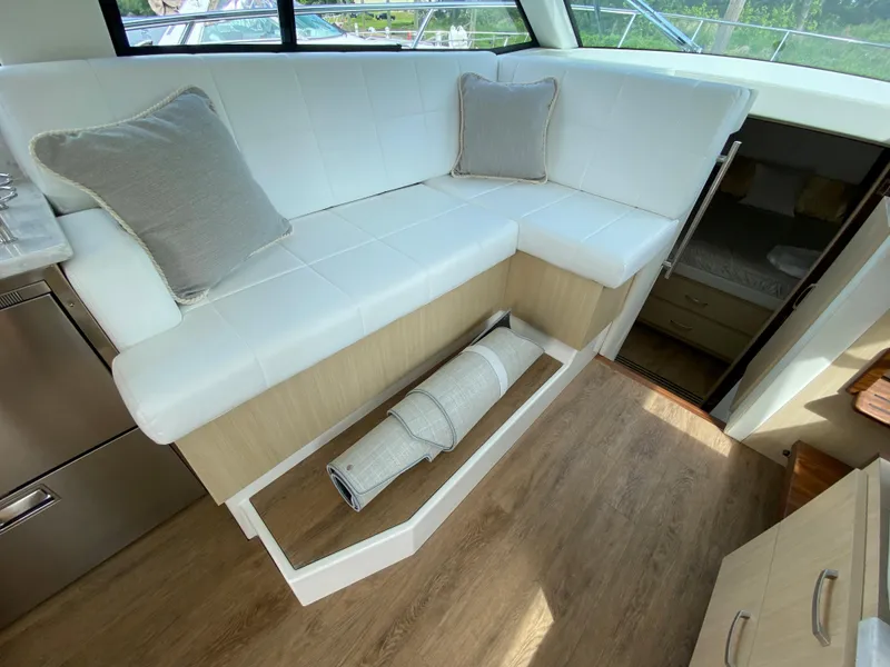 Slide: The Image of 2024 Regal 38XO yacht interior with white seating and storage compartment. - 10