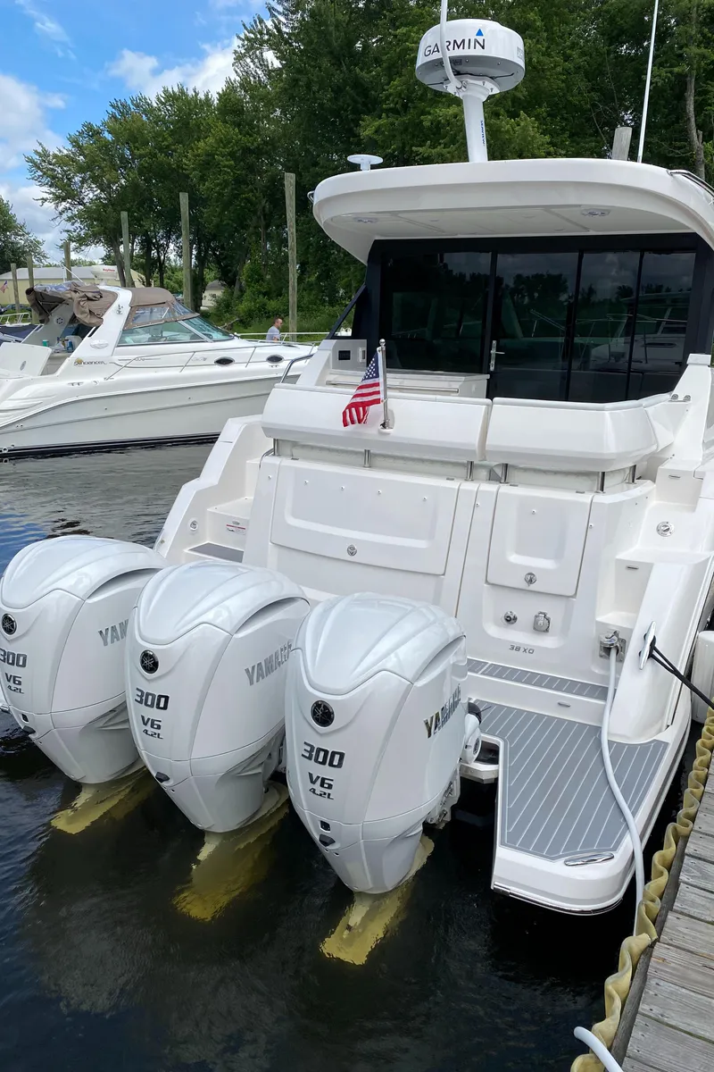 Slide: The Image of 2024 Regal 38XO boat with triple Yamaha 300 engines docked at marina. - 4
