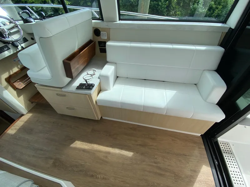 Slide: The Image of 2024 Regal 38XO interior seating area with white leather upholstery and wooden accents. - 9