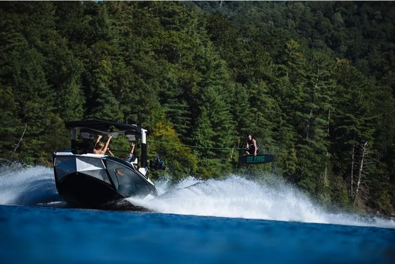 Slide: The Image of 2023 Nautique Super Air Nautique G23 Paragon towing a wakeboarder on a lake. - 21