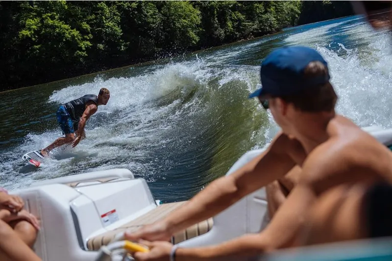 Slide: The Image of Man wakesurfing behind a 2023 Nautique Super Air Nautique G23 Paragon boat. - 22