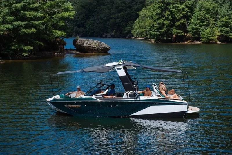 Slide: The Image of 2023 Nautique Super Air Nautique G23 Paragon on a serene lake with passengers. - 6