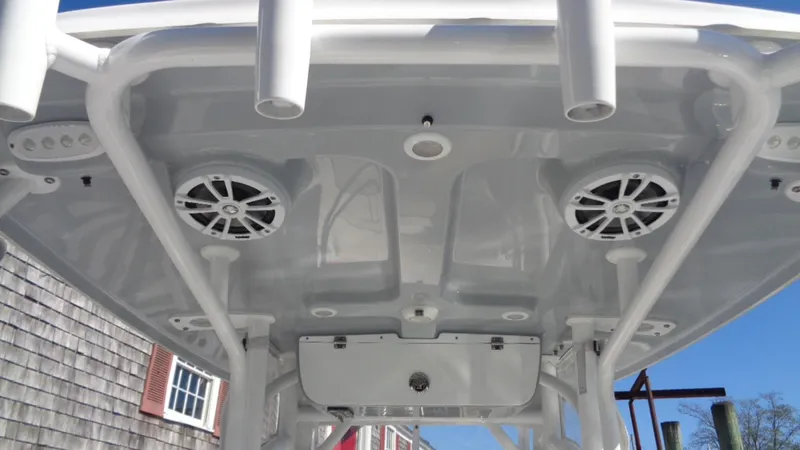 Slide: The Image of 2018 Sportsman 232 Open boat T-top with speakers and rod holders. - 10