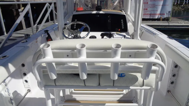 Slide: The Image of 2018 Sportsman 232 Open boat interior with rod holders and steering console. - 11