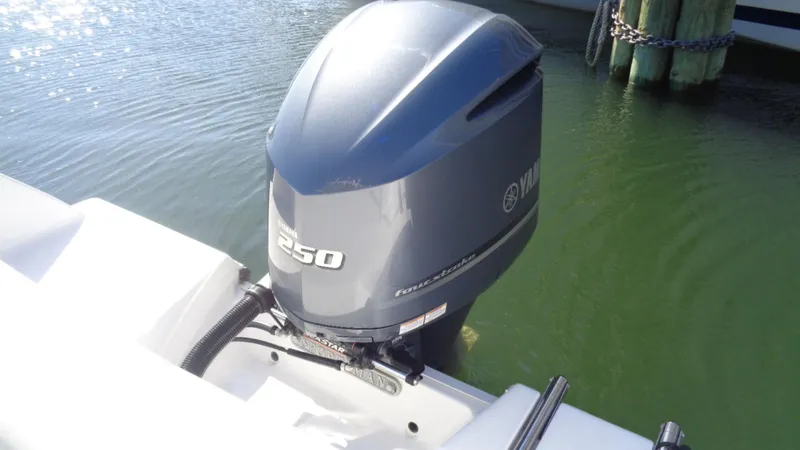 Slide: The Image of Outboard motor on 2018 Sportsman 232 Open boat, docked in calm water. - 15