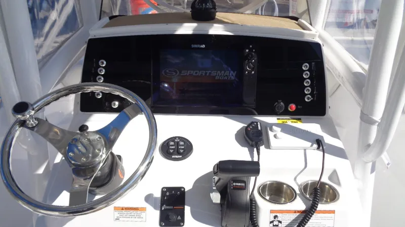 Slide: The Image of 2018 Sportsman 232 Open boat dashboard with steering wheel and control panel. - 18