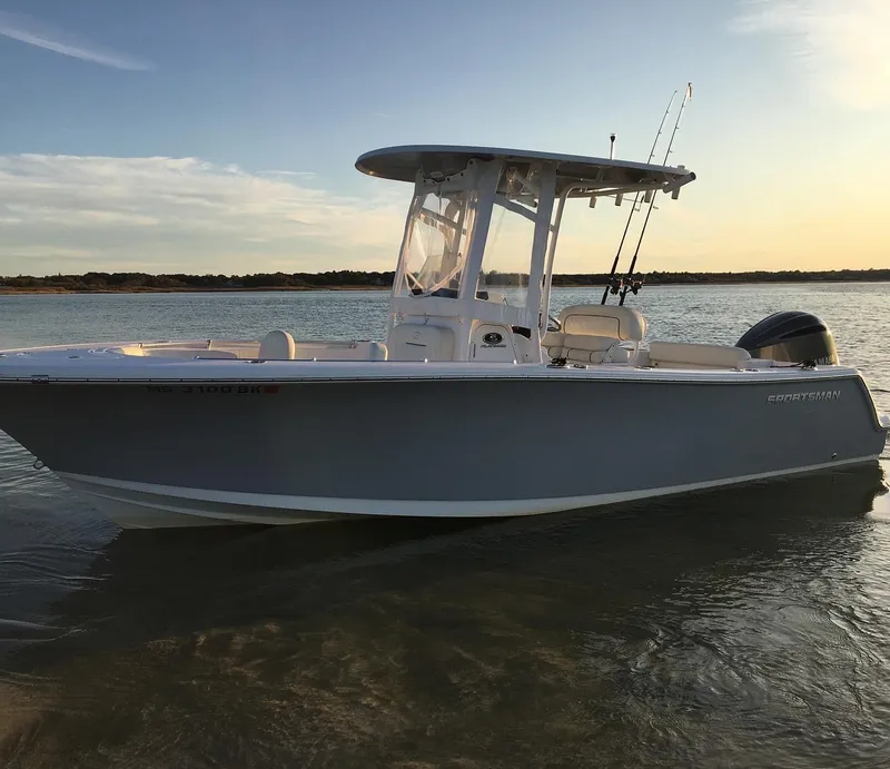Slide: The Image of 2018 Sportsman 232 Open boat on calm water at sunset. - 2