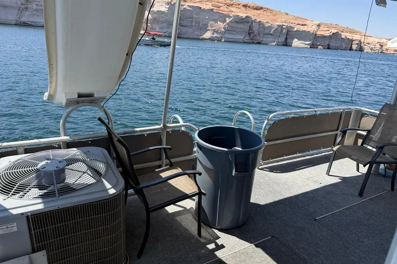 Slide: The Image of 2004 Stardust Cruisers San Juan Sunrise Trip 24 boat deck with chairs and scenic water view. - 10