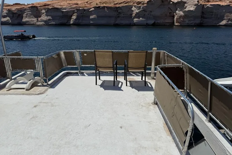 Slide: The Image of Deck view of 2004 Stardust Cruisers San Juan Sunrise Trip 24 on a scenic lake. - 14