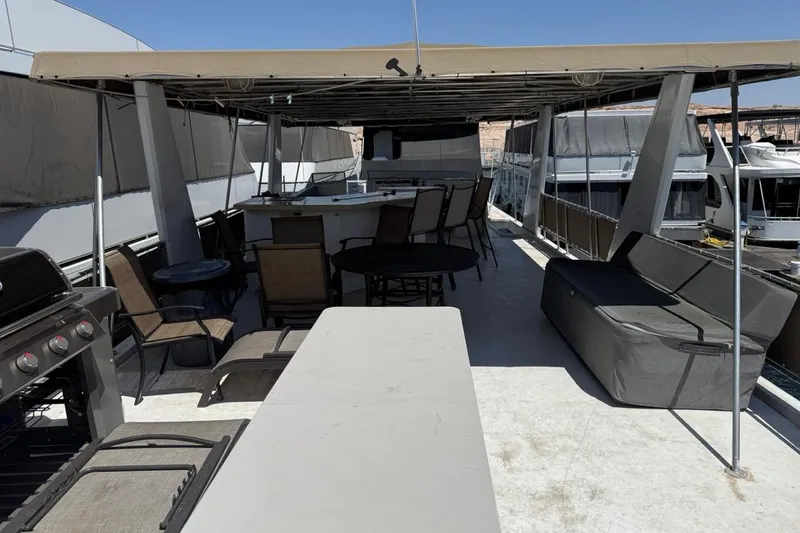 Slide: The Image of Spacious deck of 2004 Stardust Cruisers San Juan Sunrise Trip 24 with seating and grill. - 15