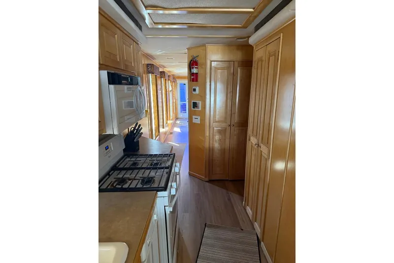 Slide: The Image of Interior of 2004 Stardust Cruisers San Juan Sunrise Trip 24, featuring a compact kitchen area. - 8