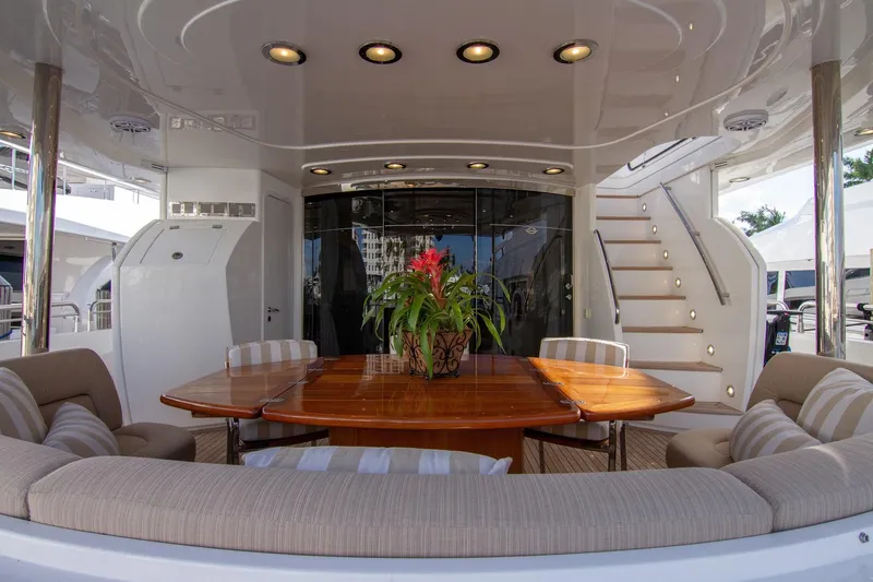 Slide: The Image of Luxurious Sunseeker 105 Yacht 2002, featuring elegant outdoor dining area with plush seating. - 10