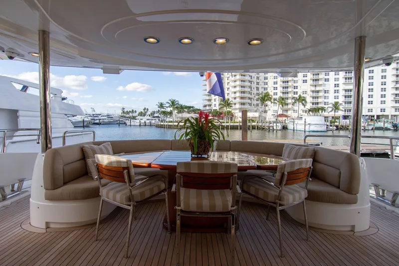 Slide: The Image of Luxurious Sunseeker 105 Yacht 2002 with elegant outdoor seating and scenic marina view. - 11