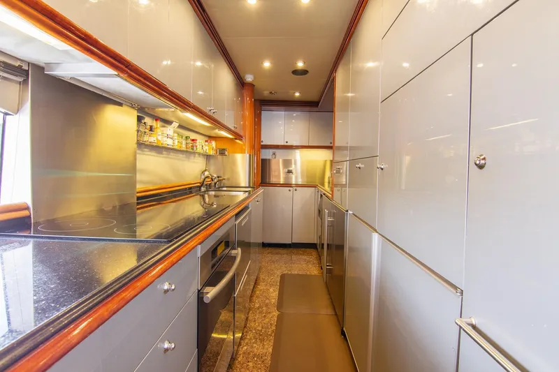 Slide: The Image of Luxurious kitchen interior of a 2002 Sunseeker 105 Yacht, featuring modern appliances and sleek cabinetry. - 19