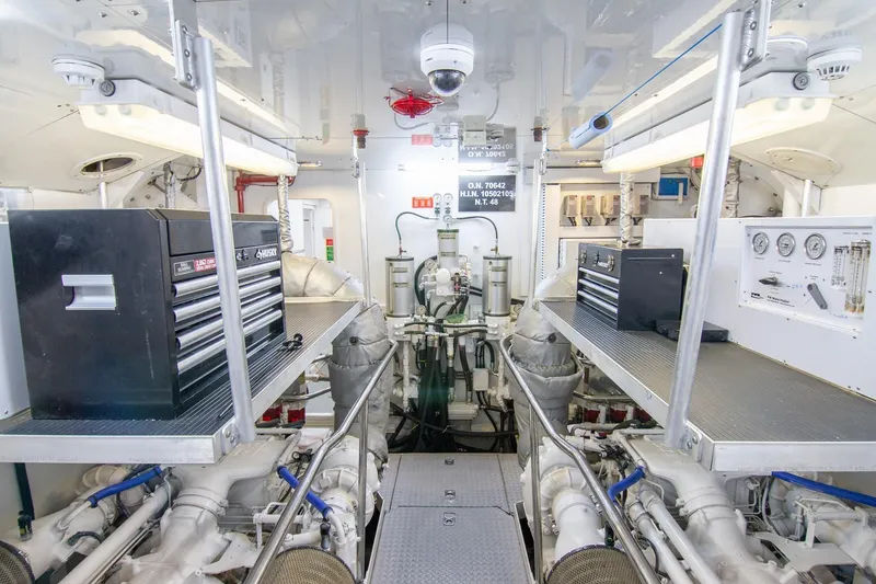 Slide: The Image of Engine room of a 2002 Sunseeker 105 Yacht, featuring toolboxes and mechanical equipment. - 21