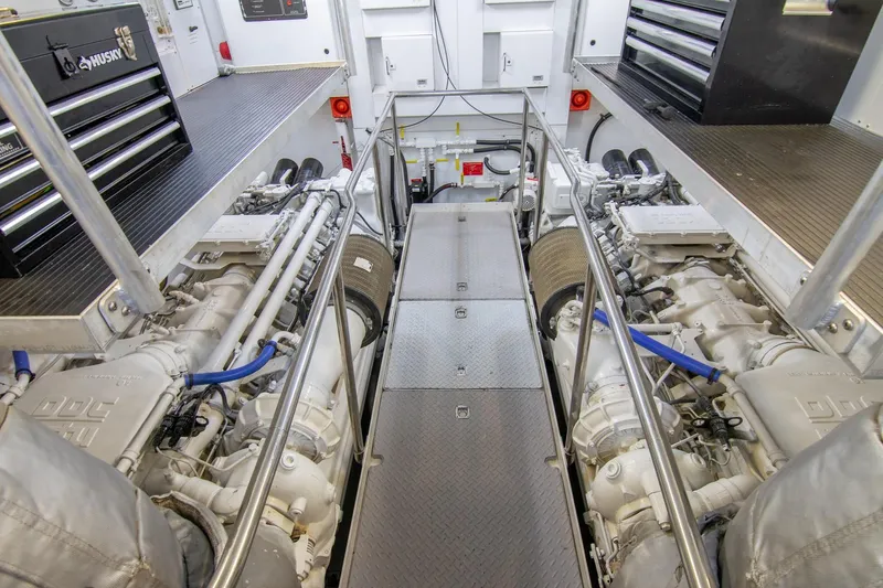 Slide: The Image of Engine room of a 2002 Sunseeker 105 Yacht, featuring dual engines and organized workspace. - 22