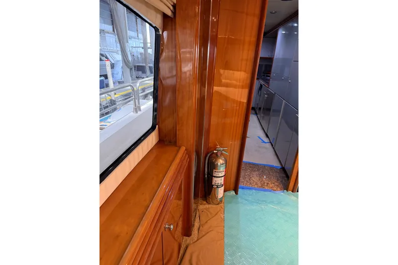 Slide: The Image of Interior of 2002 Sunseeker 105 Yacht with polished wood and fire extinguisher. - 24