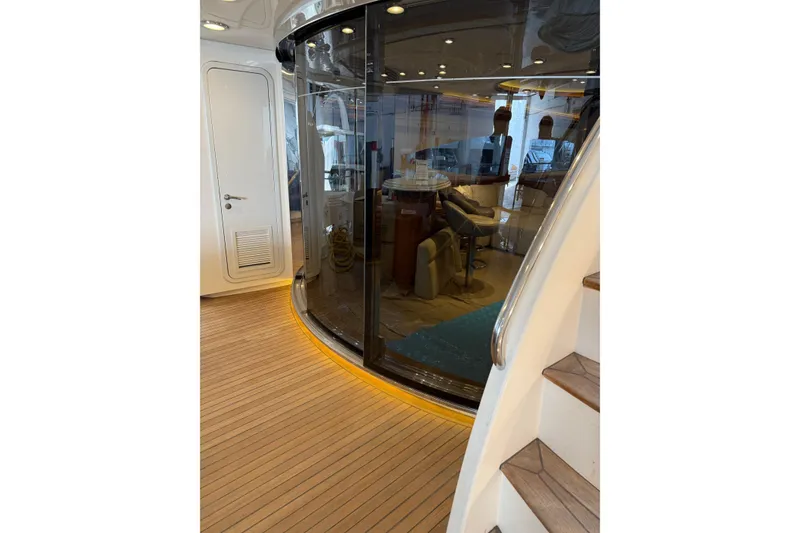 Slide: The Image of Interior view of 2002 Sunseeker 105 Yacht with modern design and wooden flooring. - 26