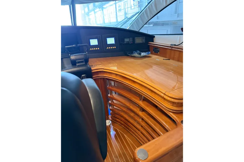 Slide: The Image of Luxurious wooden helm of a 2002 Sunseeker 105 Yacht with modern navigation displays. - 31