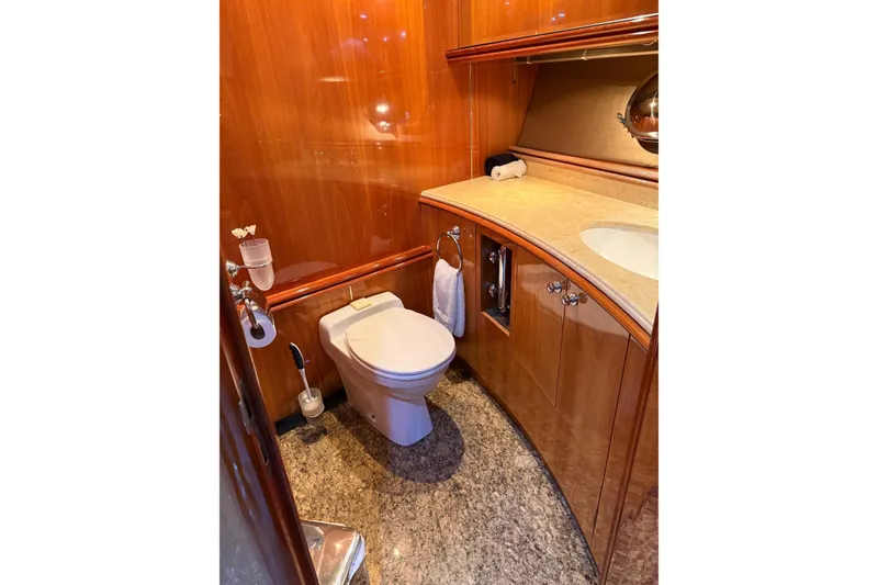 Slide: The Image of Luxurious bathroom interior on a 2002 Sunseeker 105 Yacht, featuring wood paneling and marble flooring. - 36