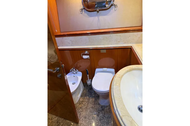 Slide: The Image of Luxurious bathroom on a 2002 Sunseeker 105 Yacht with elegant wood and marble finishes. - 38